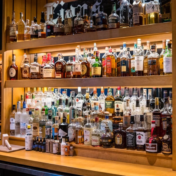 A well-stocked bar at The Noble Lion, featuring shelves filled with various liquor bottles.